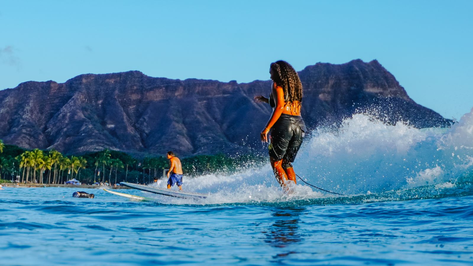 Woman in bikini surfing